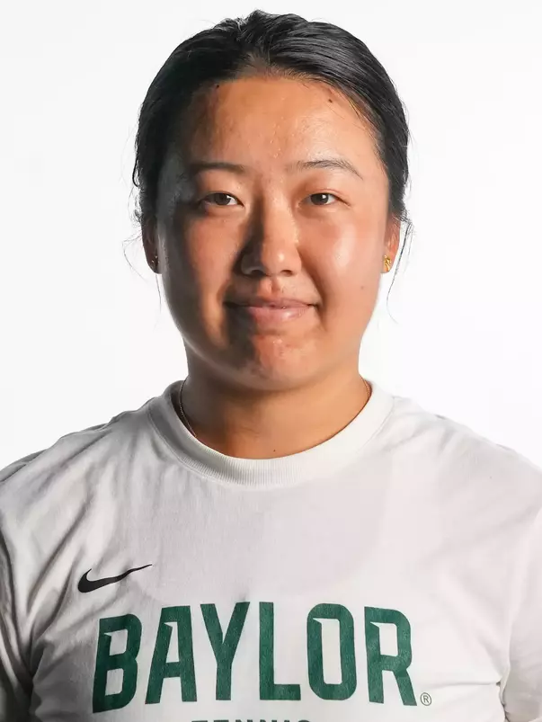 Na Dong smiling in headshot in front of white backdrop