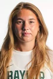 Maria Ustic smiling in headshot in front of white backdrop