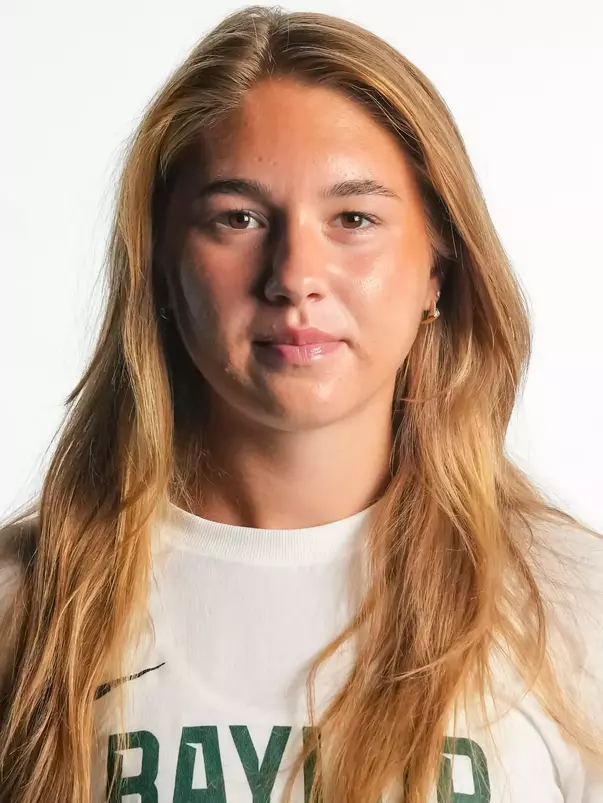 Maria Ustic smiling in headshot in front of white backdrop