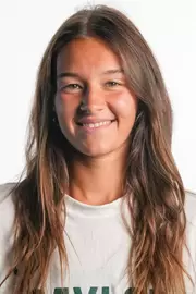 Alian Zack smiling in headshot in front of white backdrop