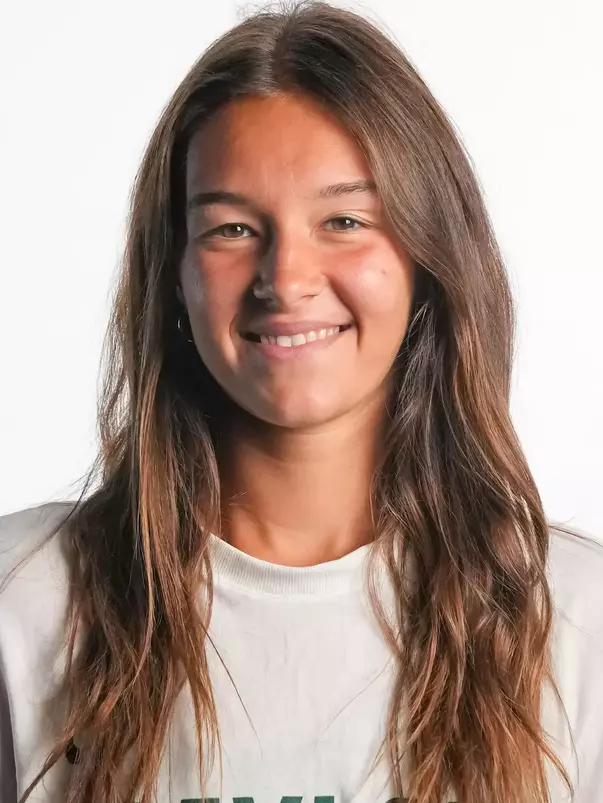 Alian Zack smiling in headshot in front of white backdrop