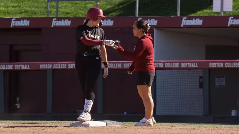Coach Katie Watts and Emma Knight at First Base