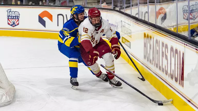 Jake Sondreal fighting for the puck against Alaska