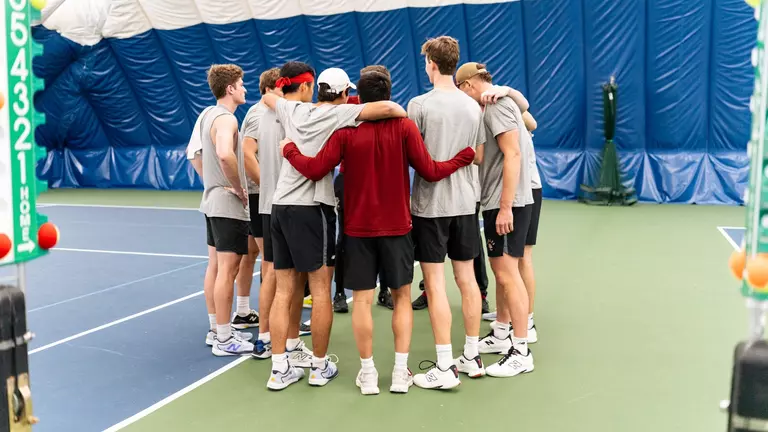 men's tennis groups huddle