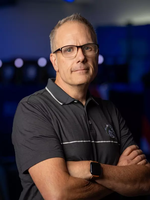 Doc Haskell standing with his arms crossed