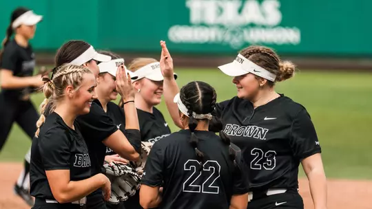Brown softball huddle at Texas State
