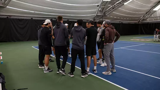 Men's Tennis Huddle Against Merrimack