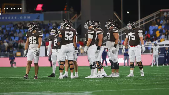 Football Huddle Against Rhode Island