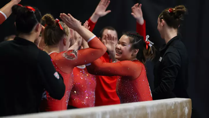 Delaney McMahon celebrates her beam routine at WMU