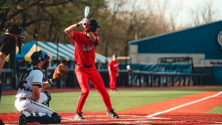Brett Griffiths takes an at-bat against Kent State on April 17th, wearing a red jersey.