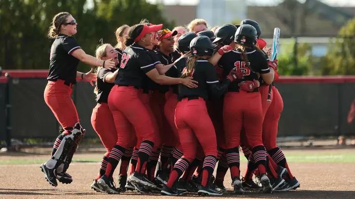 Ball State softball team celebrating after earning a senior day victory over Kent State at the Ball State softball stadium.