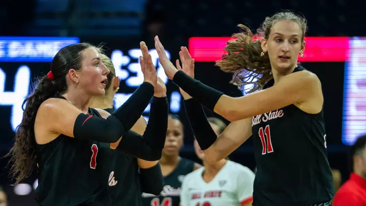 Tiffany Snook and Audrey Geer high five during introductions of the team's match versus Dayton