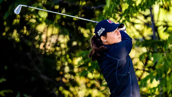 Lexi Ray taking an iron shot with trees in the background at the Brittany Kelly Classic