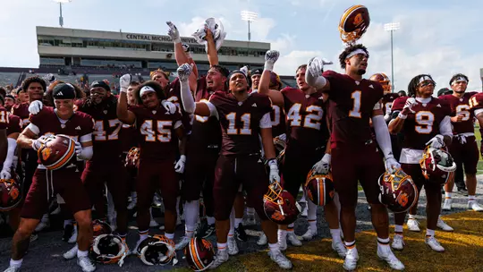 Team celerates with the Central Michigan marching band after a Central Michigan win against Colgate football on Saturday Sept. 12, 2026 in Mount Pleasant. (Ty Klopf/Central Michigan Football)
