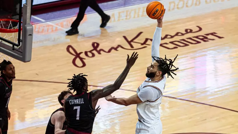 Christian Reeves shotos the ball over defender