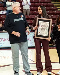 Bre Bolden with former coach after having her jersey lifted in the rafters