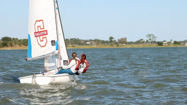 College of Charleston sailing in a dinghy boat.