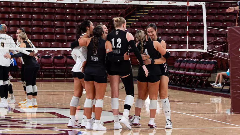 Violet Poole and Helena Vukovic hugging after a Charleston point.