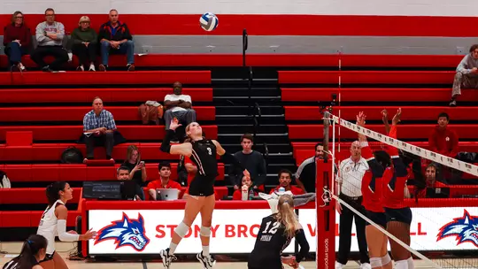 Julia Gnida jumping to hit a volleyball at Stony Brook Oct. 16.