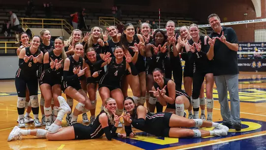 College of Charleston volleyball celebrating head coach Jason Kepner's 400th career win.