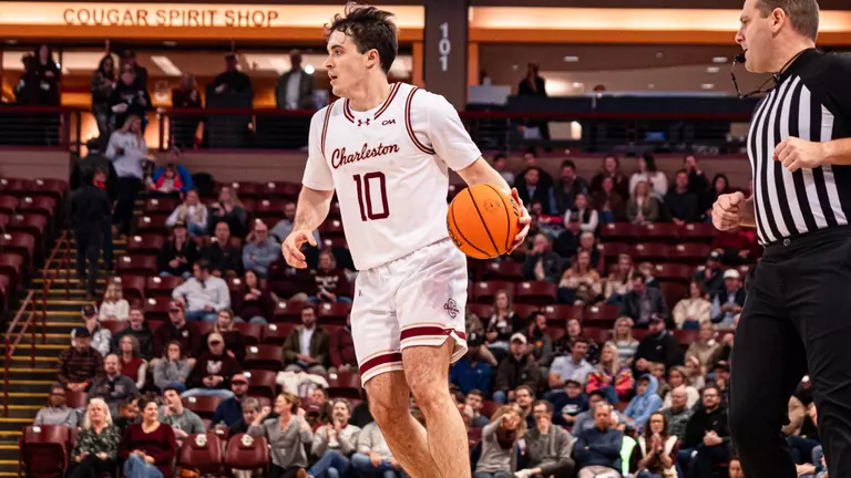 Connor Hickman dribbles the basketball