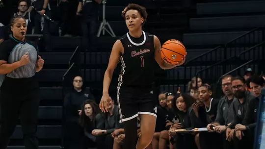 Leah Philpotts brings ball up the court at Monmouth