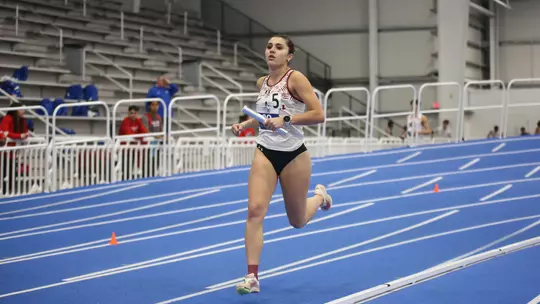 Andie Harding running with the relay baton