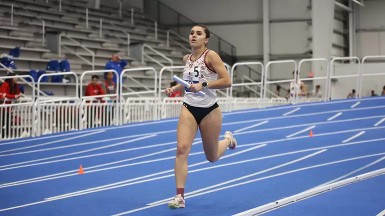 Andie Harding running with the relay baton