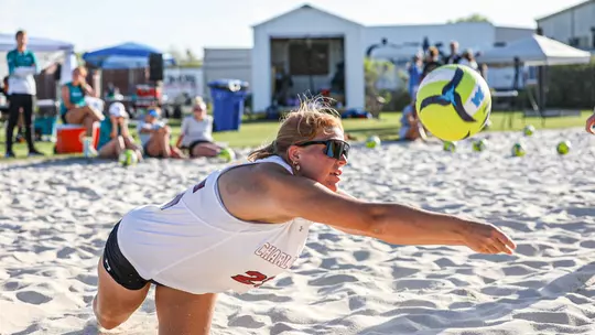 Ella Duffner dives for the ball in the sand