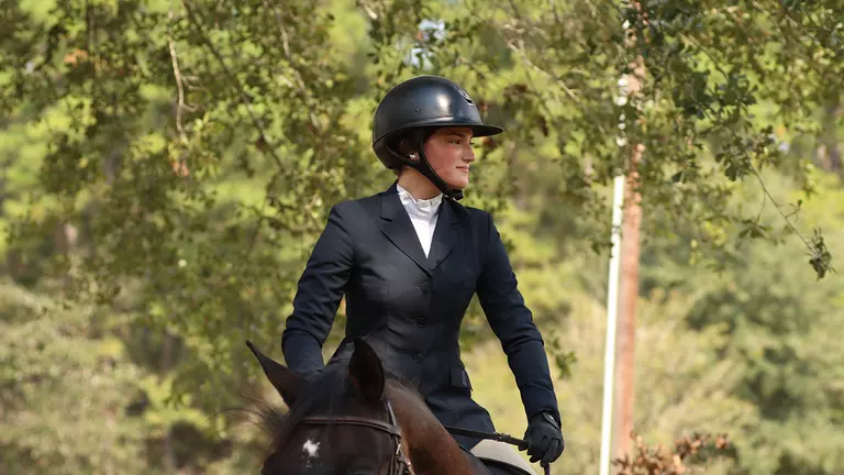 Lily Kress-Davies riding a horse during competition.