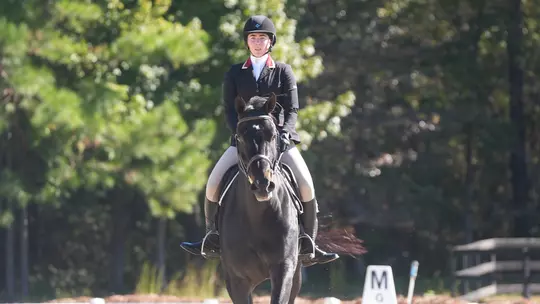 Sydney Callagy riding a horse at White Horses, LLC.