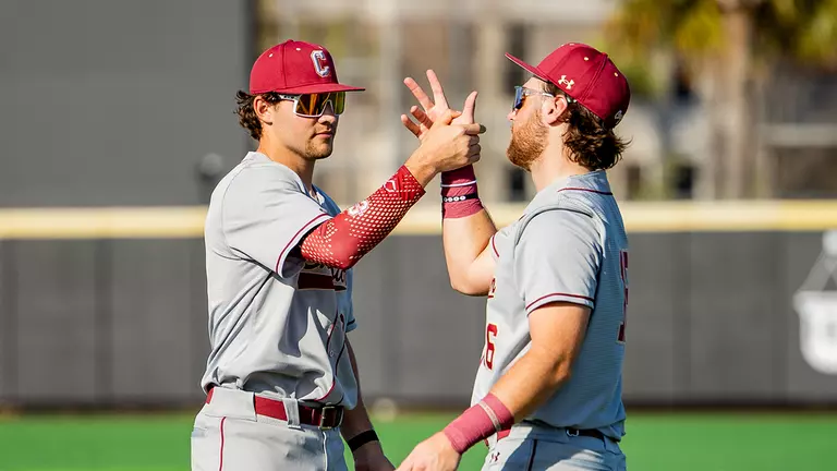 Jake Amman and Landon Penfield doing a handshake pregame.