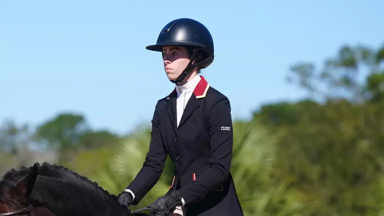 Kenda Murray riding a horse at an NCEA meet.