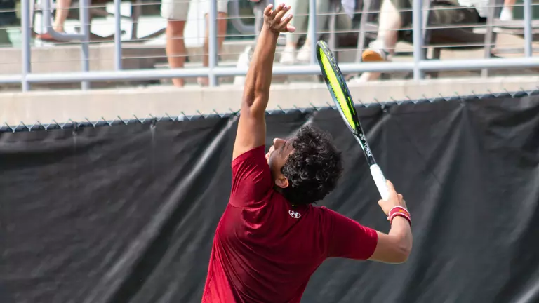 Dani Farran serves tennis ball