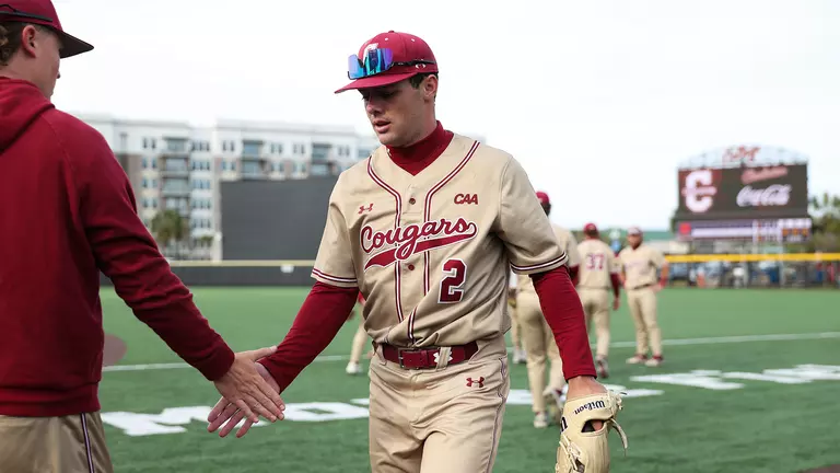 Reece Holbrook giving a high five to a teammate.