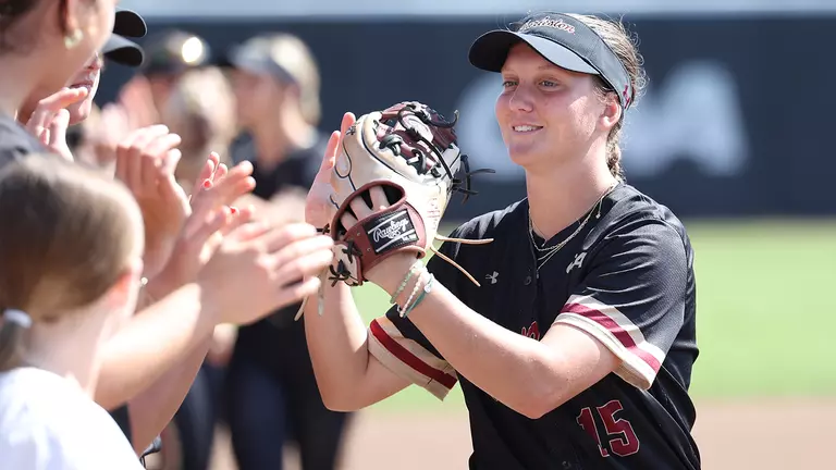 Cadence Alberty high fiving her teammates