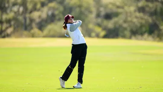 Molly Hardwick finishes her swing
