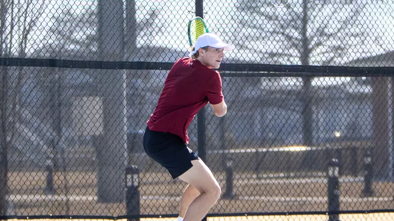 Leon Harder hits tennis ball