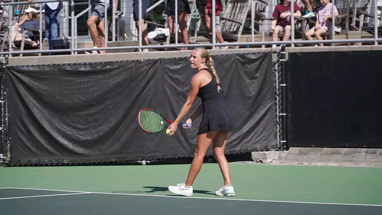 Riley Trinkle serves tennis ball