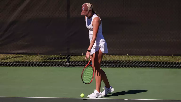 Saige Severance gets ready to serve tennis ball