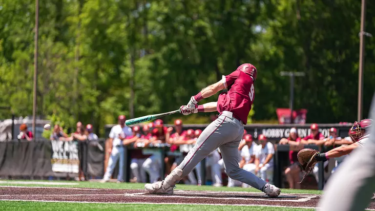Dylan Johnson hitting a baseball May 10 at Elon.
