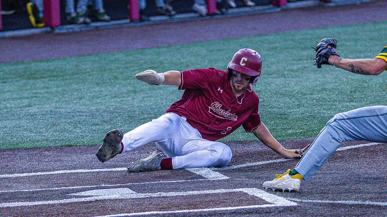 Jake Amman sliding into home plate May 15 vs William & Mary.