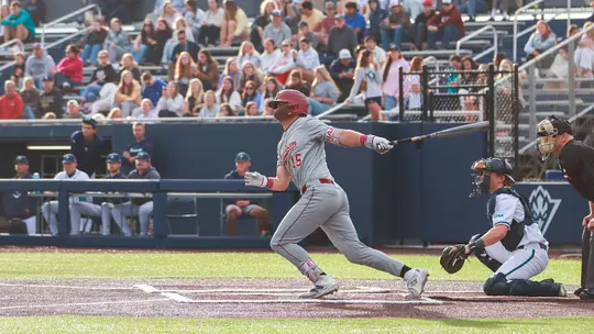 Ethan Plyler swinging a baseball bat at UNCW.