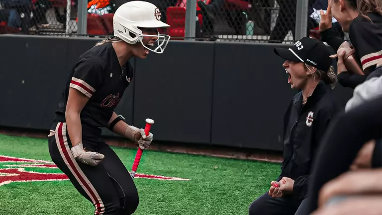 Bronwyn Conroy and Coach Mrowka celebrating in the dugout