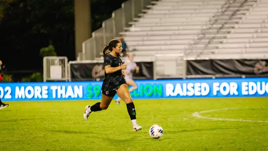 Casey Malone running down the field with the ball