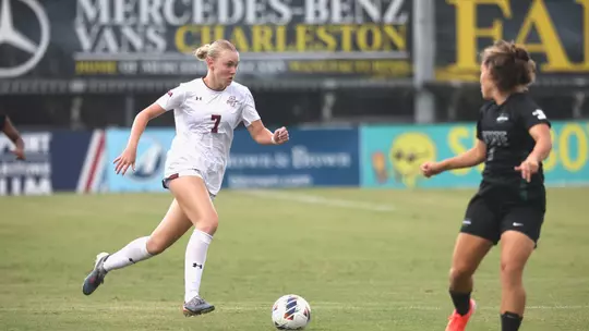 Mary Martin Spinner running down field with the ball