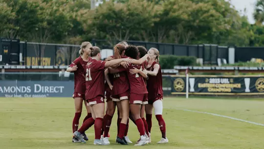Women's Soccer team goal celebration huddle