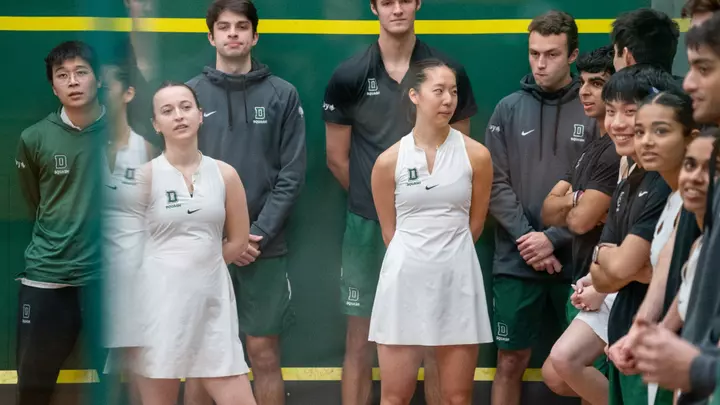 Squash team stands on the court prior to a match