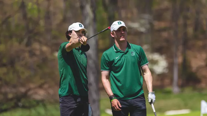 Brand and Harper look at a hole