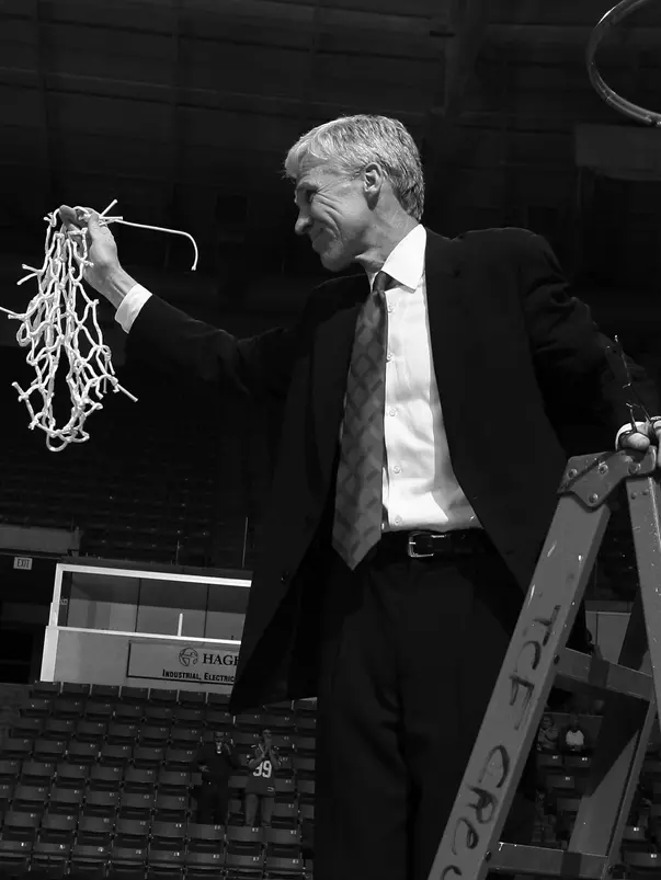 Bob McKillop cuts down a net in March.
